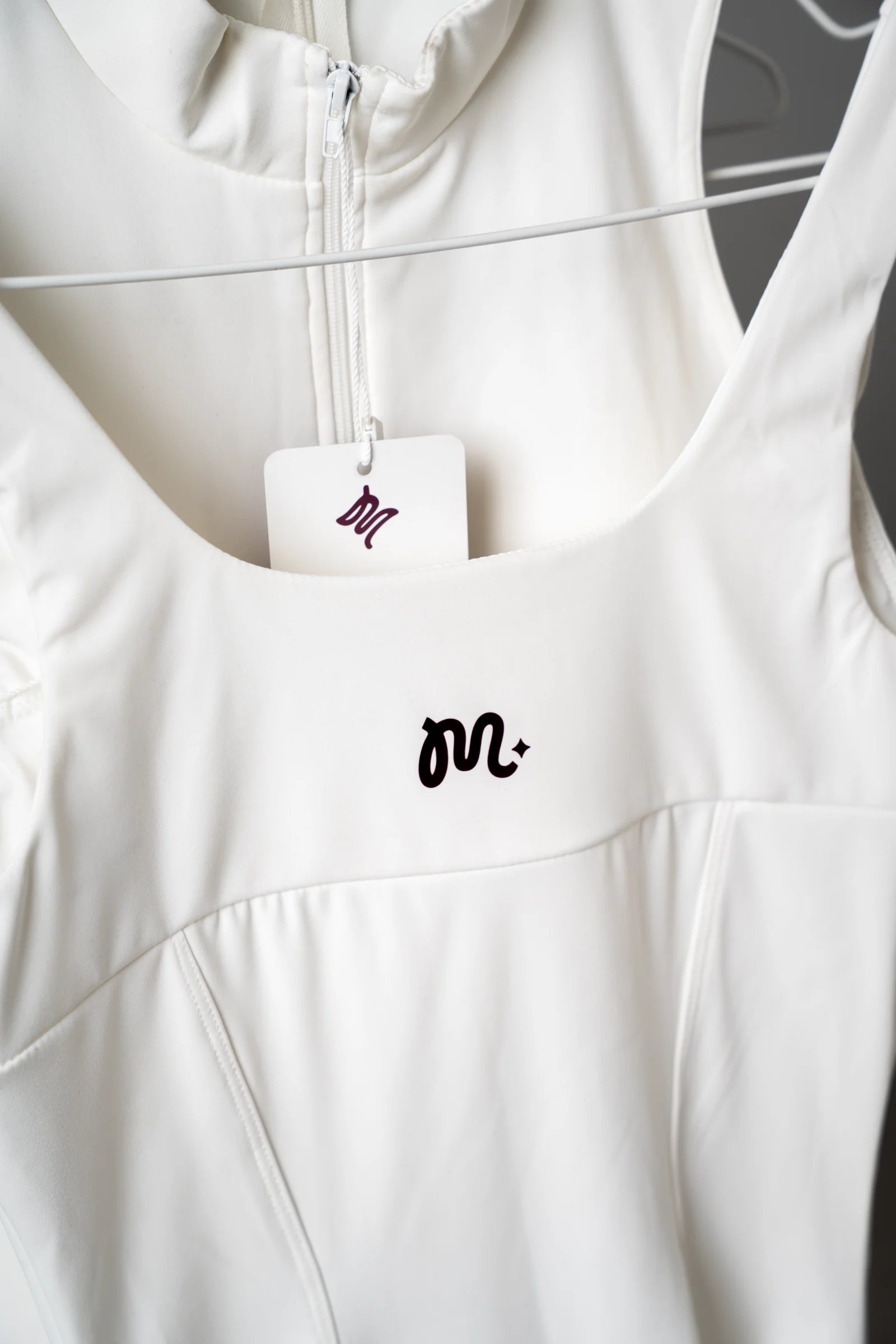 MALU woven label on a cream dress